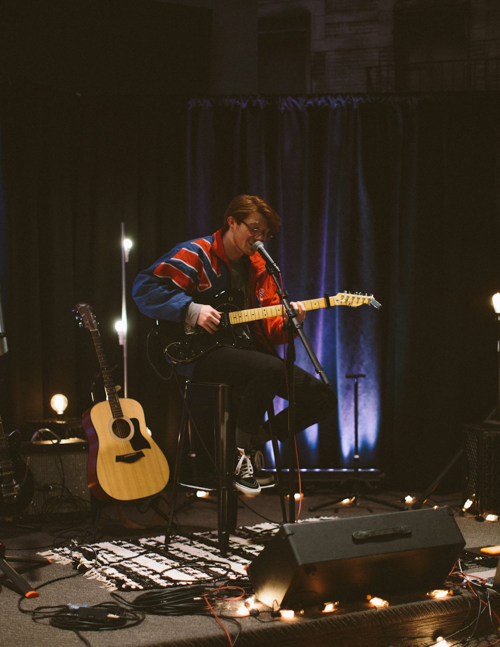 man singing while playing guitar