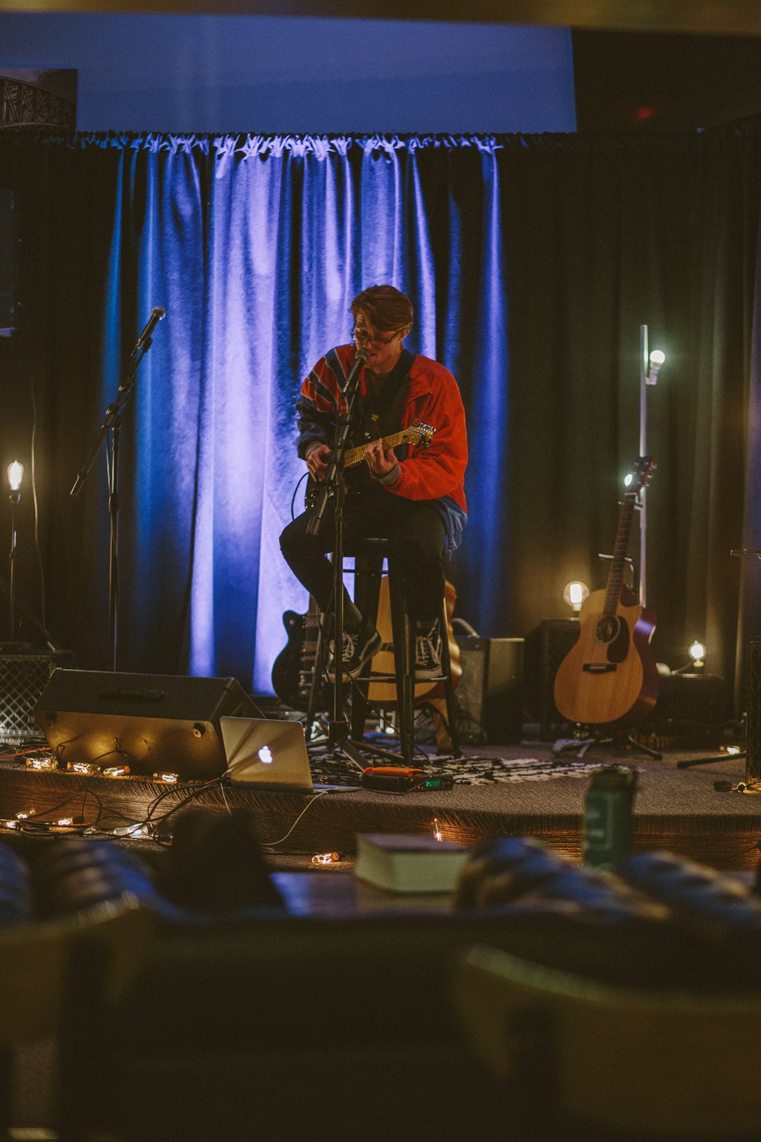 man playing guitar on stage