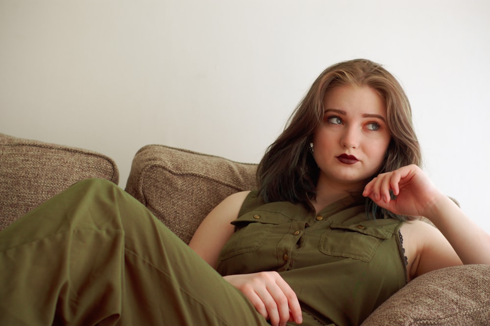 woman sitting on brown sofa