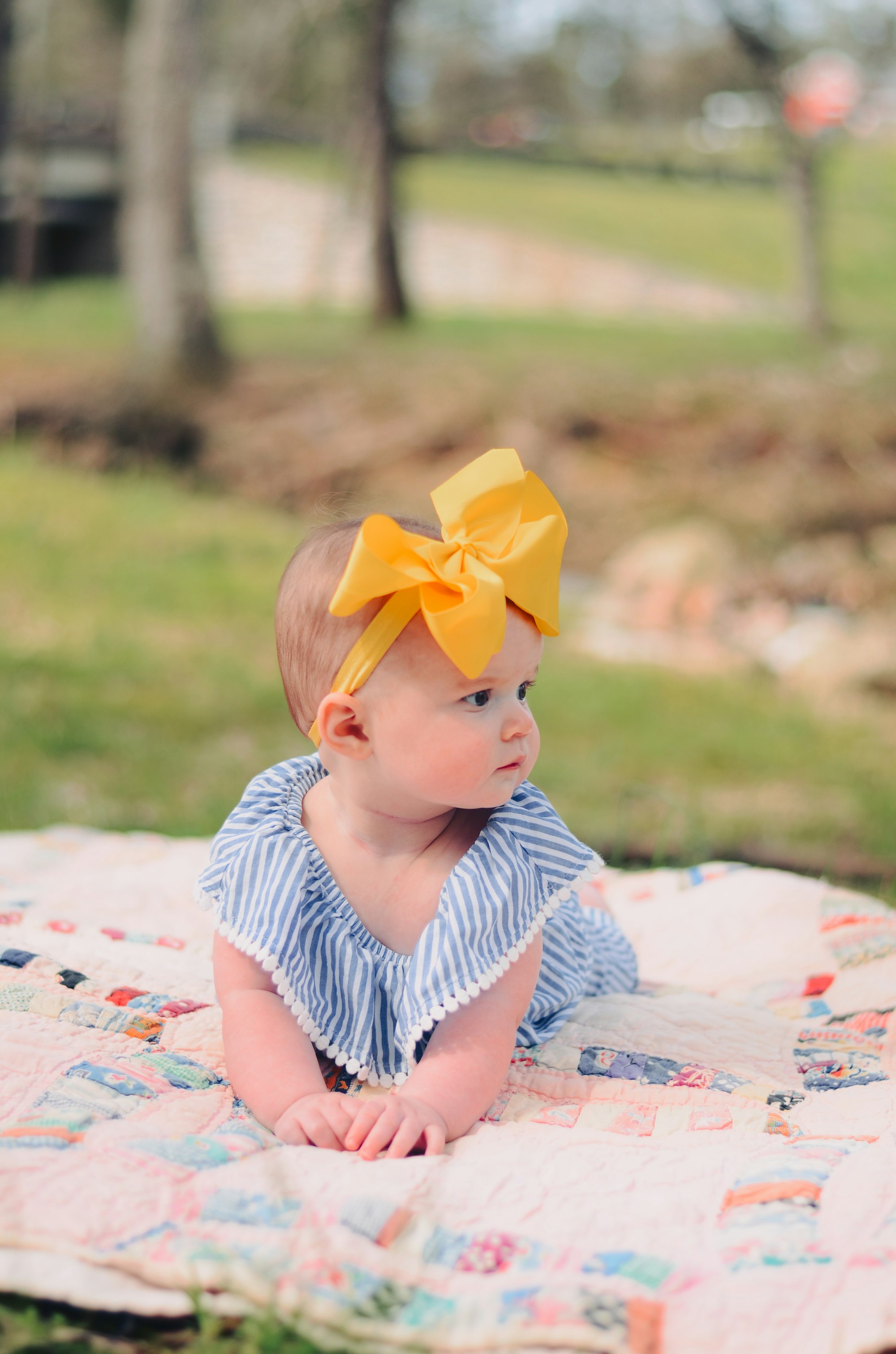 baby with bow, tummy time, baby picture, baby in blue