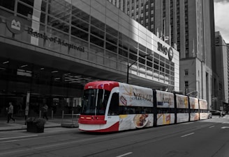 A vibrant rideshare car wrapped in colorful advertising cruising through downtown Toronto streets.