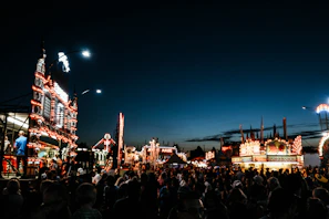 Evening scene of a food festival with vibrant stalls and happy visitors.