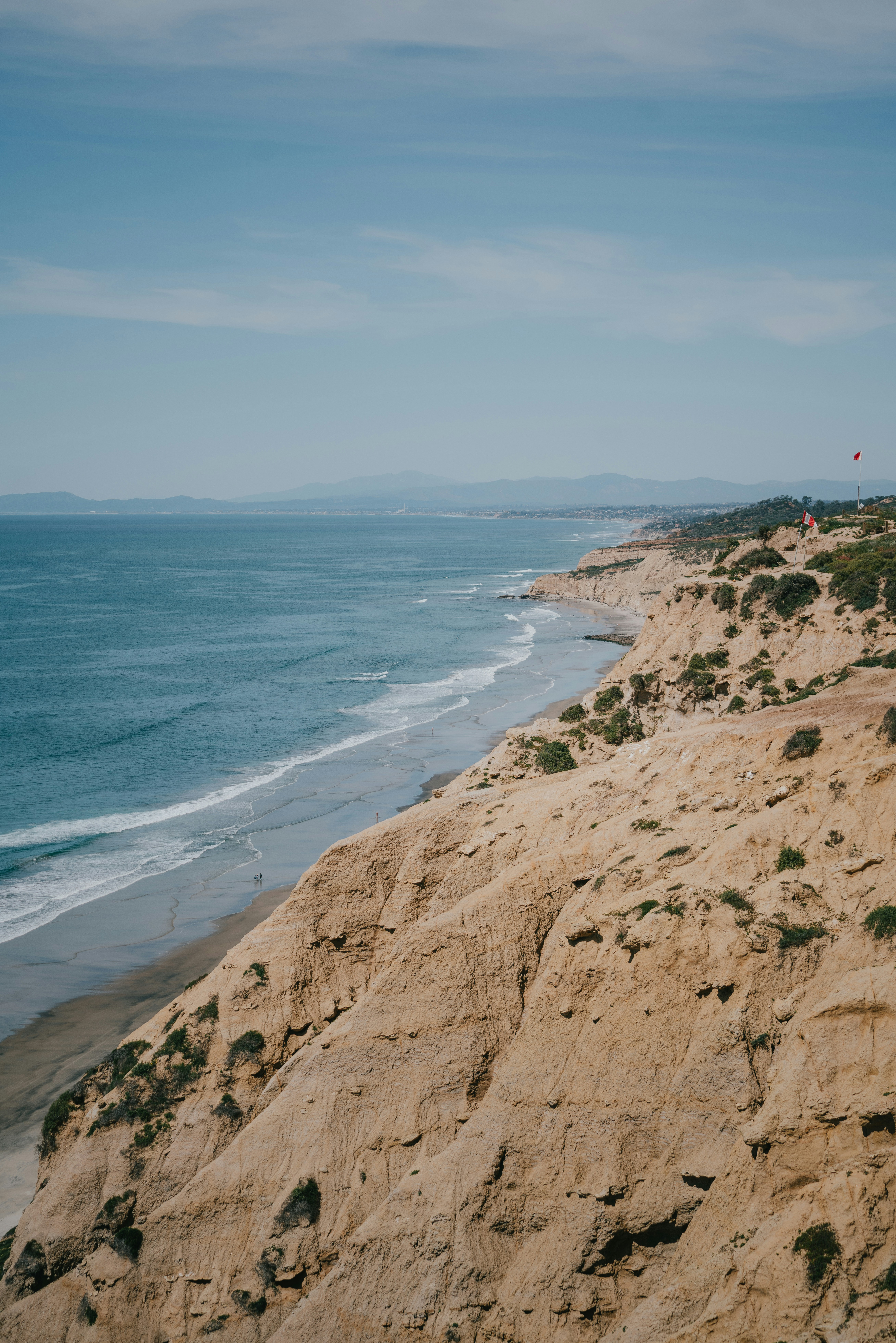 brown rock formation near body of water during daytime