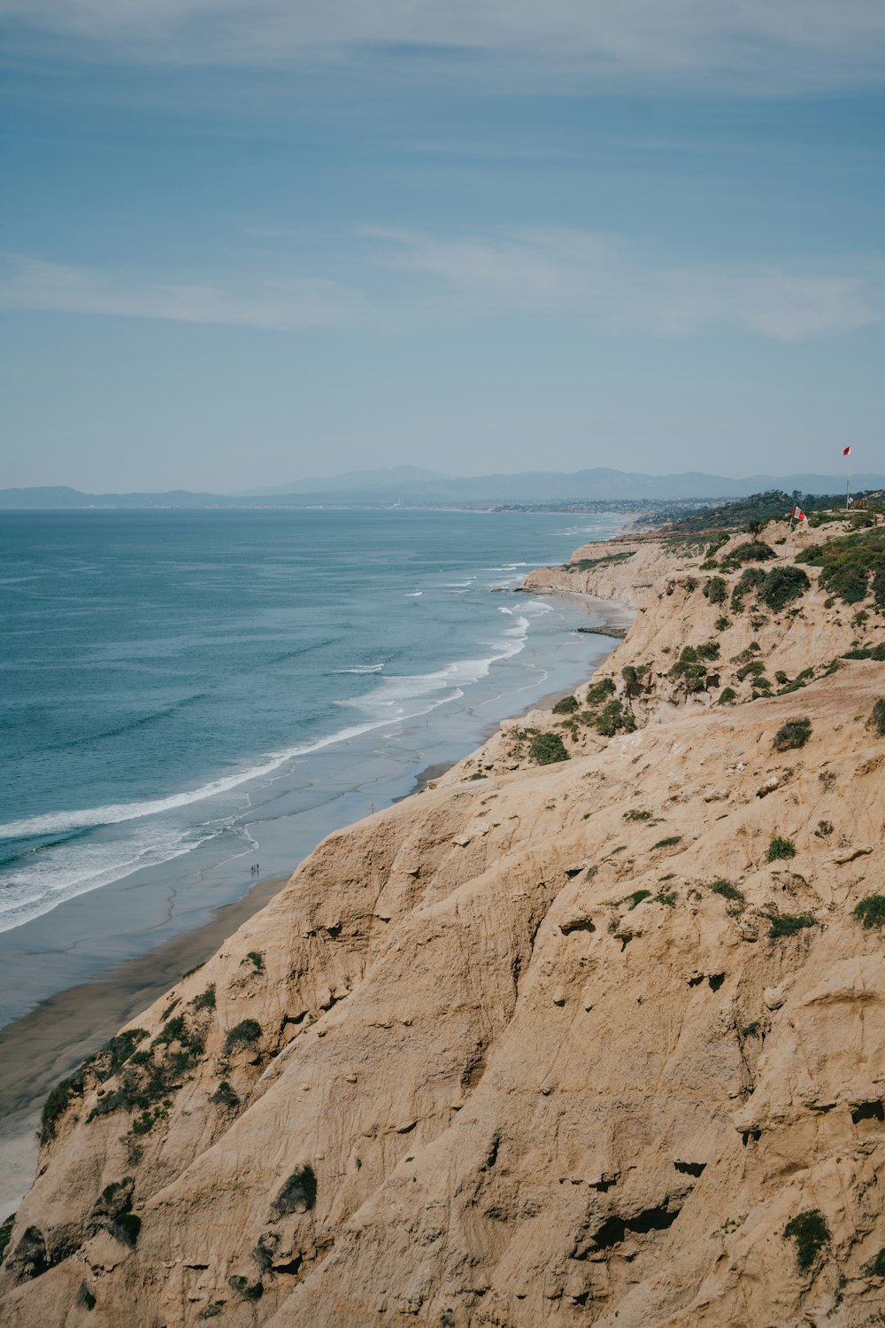 brown rock formation near body of water during daytime