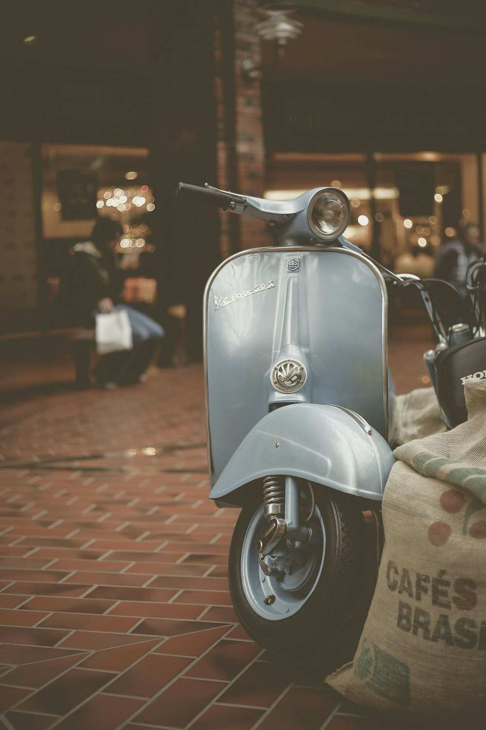 blue mini scooter parked beside brown sack