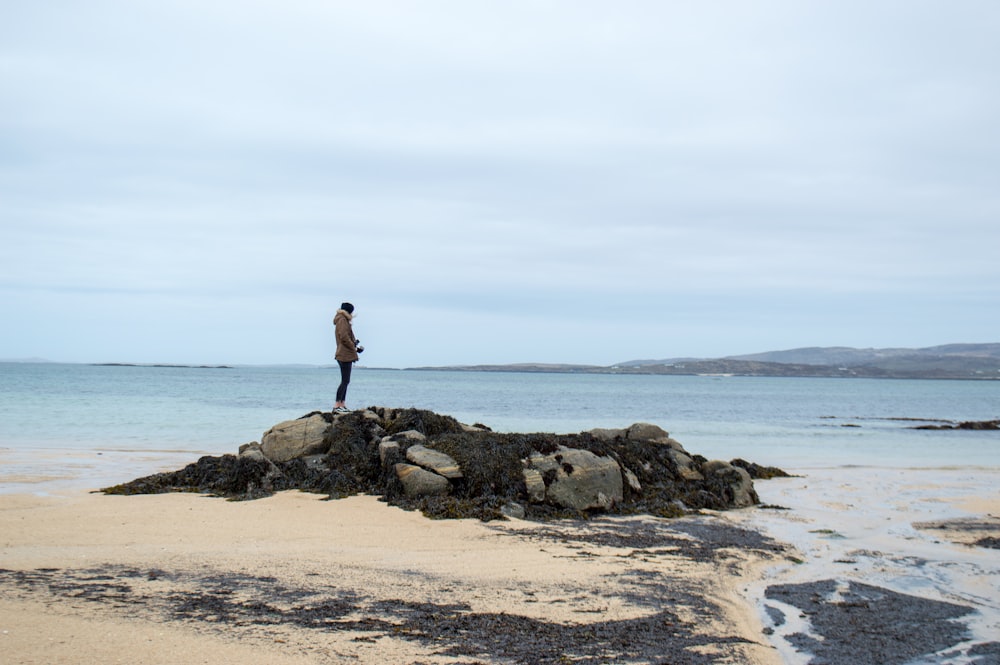 person standing on rock formation