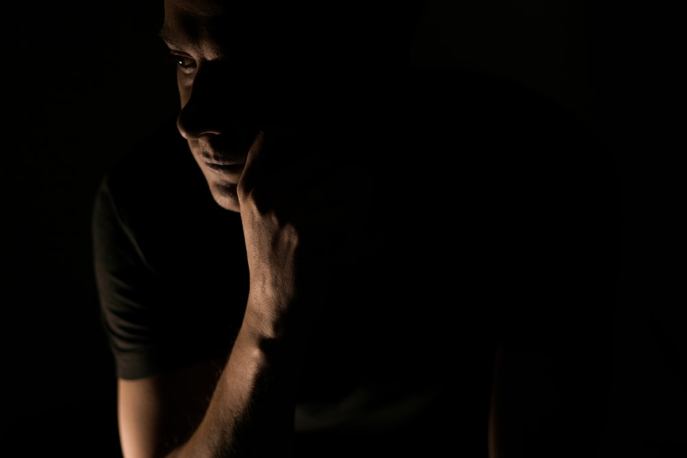 man in black shirt inside dark room