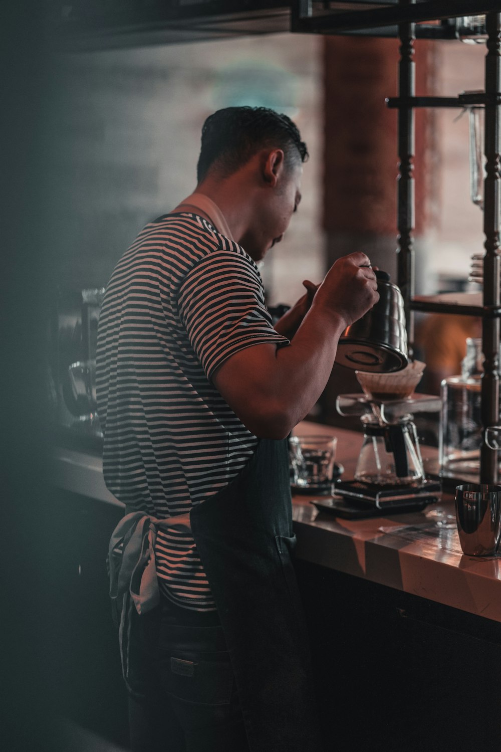 man pouring beverage on coffee carafe