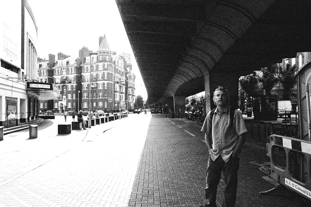 man standing on sidewalk