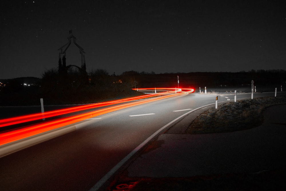 time-lapse photography of passing vehicles on road