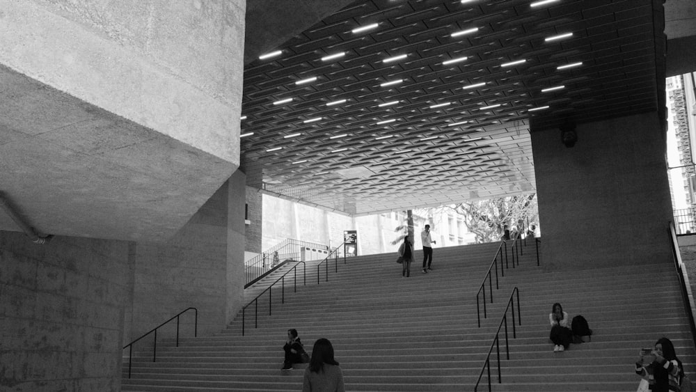 group of people standing and sitting on the stairs