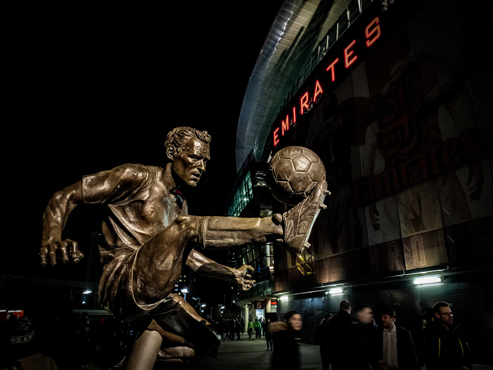A bronze statue of a footballer outside the Emirates Stadium, home of Arsenal