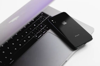 A sleek laptop and smartphone side by side displaying the same responsive website layout.