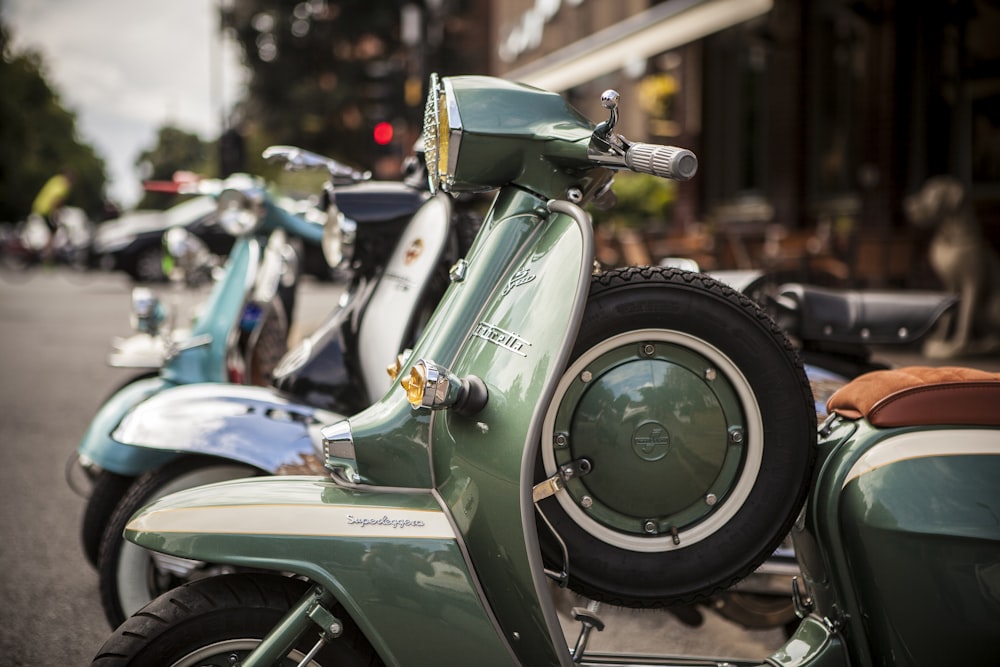 selective focus photography of several motor scooters on parking lot