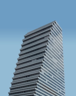 low angle photography of white concrete building during daytime