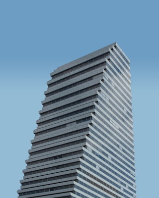 low angle photography of white concrete building during daytime
