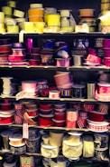 Assorted ribbons with different patterns and textures displayed on a shelf.