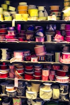 A close-up of colorful ribbons and materials used for crafting hair accessories.