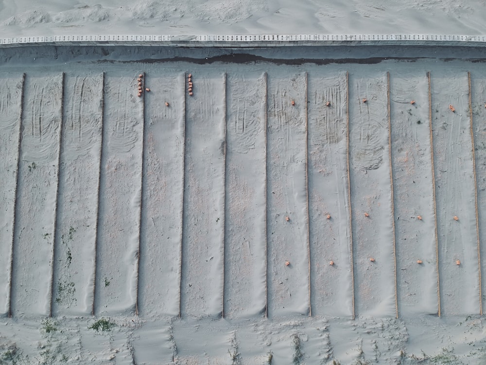 an aerial view of a snowboarder going down a hill