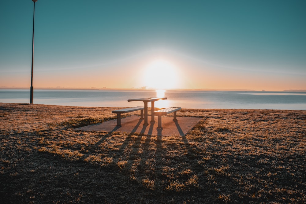 empty table and benches on sand