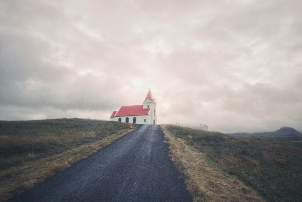 white and red cathedral under cloudy sky