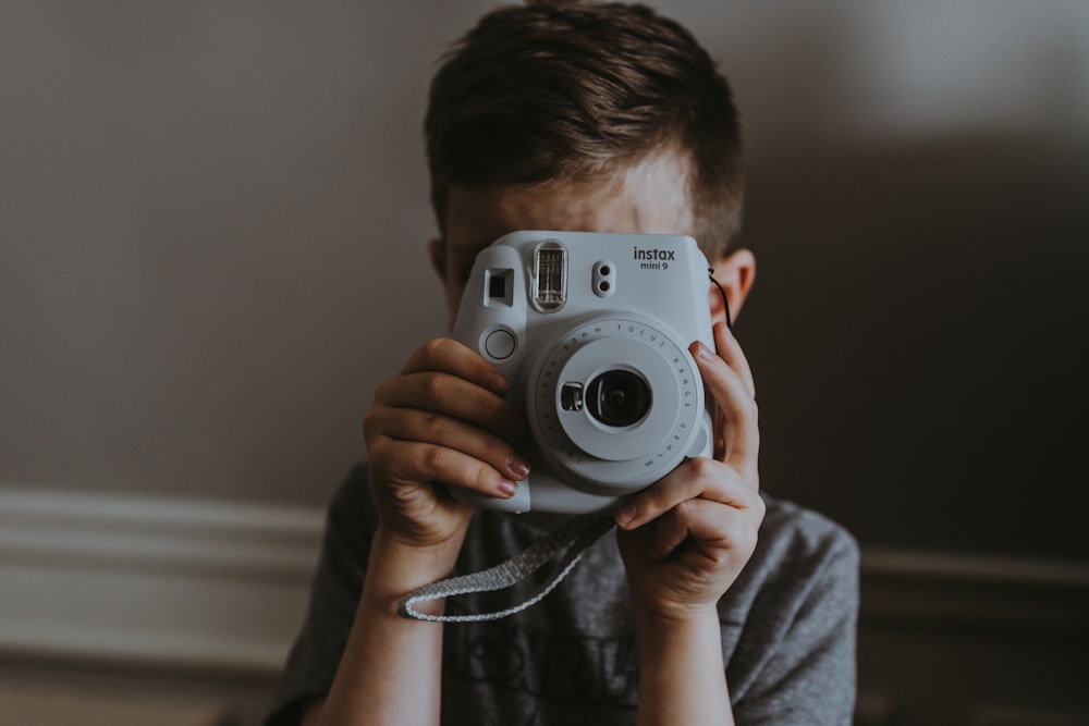 child taking picture