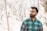 man standing near wood s