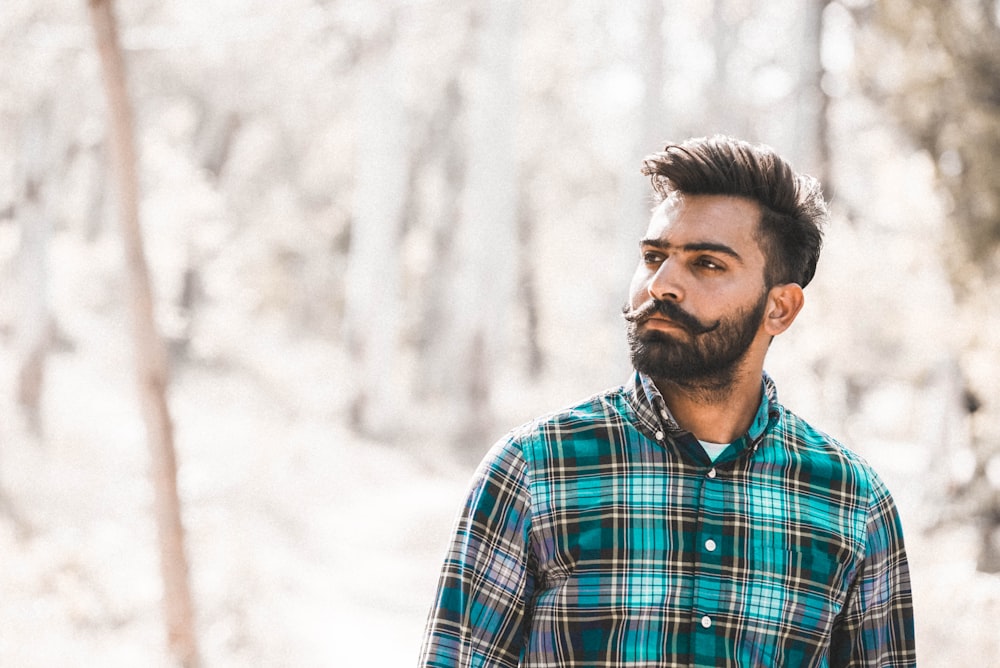 man standing near wood s