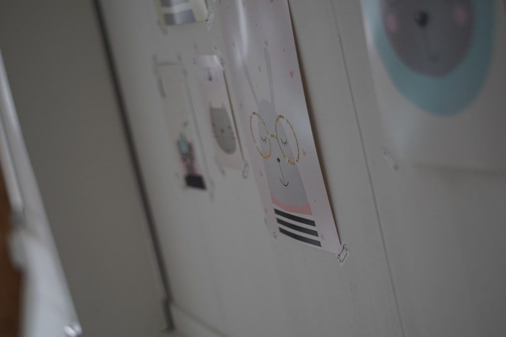 a close up of a refrigerator with magnets on it