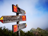Close-up of a wooden signpost marking trekking routes in the Chilean mountains