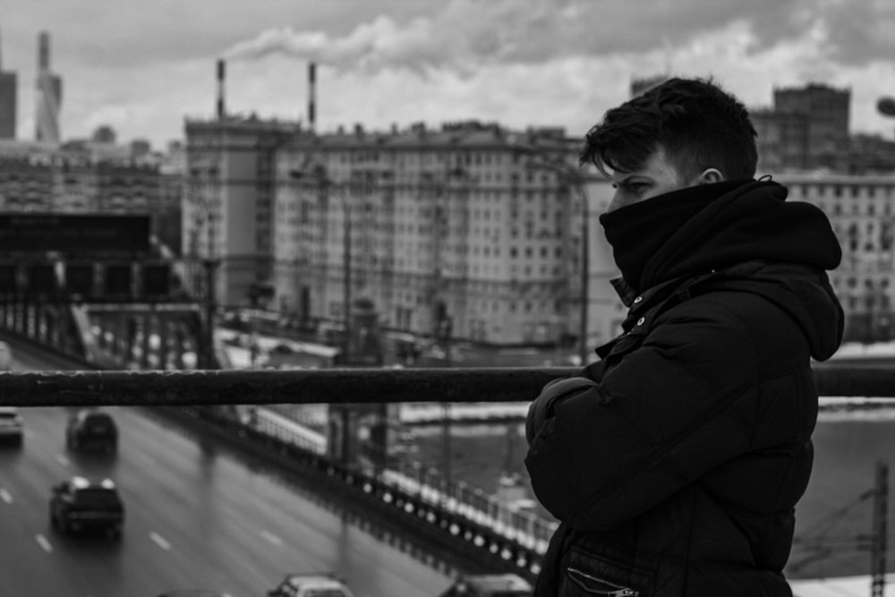 grayscale photography of man wearing jacket