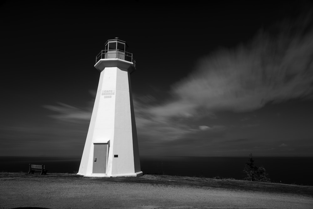 white concrete lighthouse grayscale photography