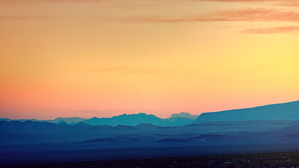 a view of a mountain range at sunset