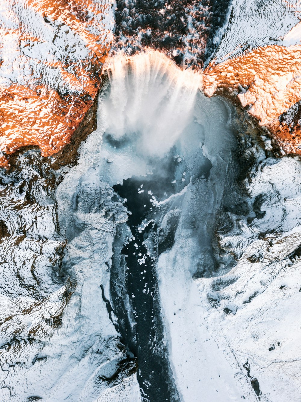 waterfalls in between of white rock formation