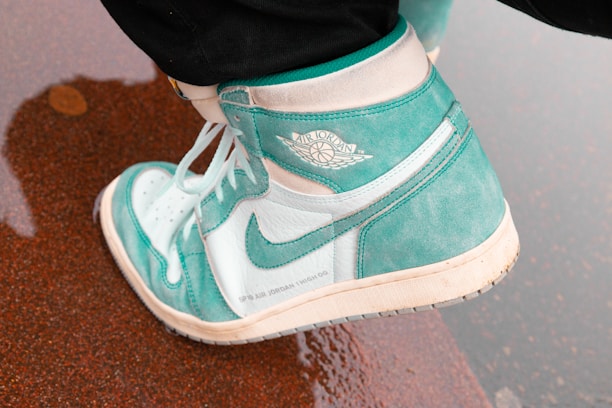 unpaired teal and white Nike Air Jordan 1