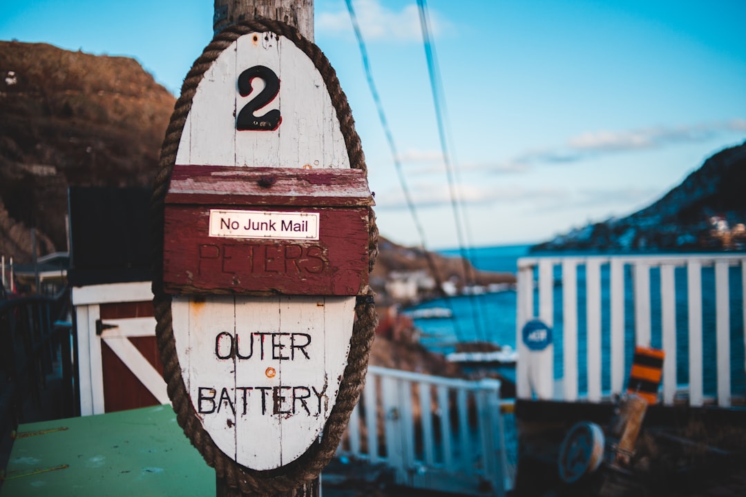 selective focus photo of outer battery signage on post