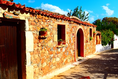 Exterior view of the charming stone building surrounded by lush greenery in Asciano.