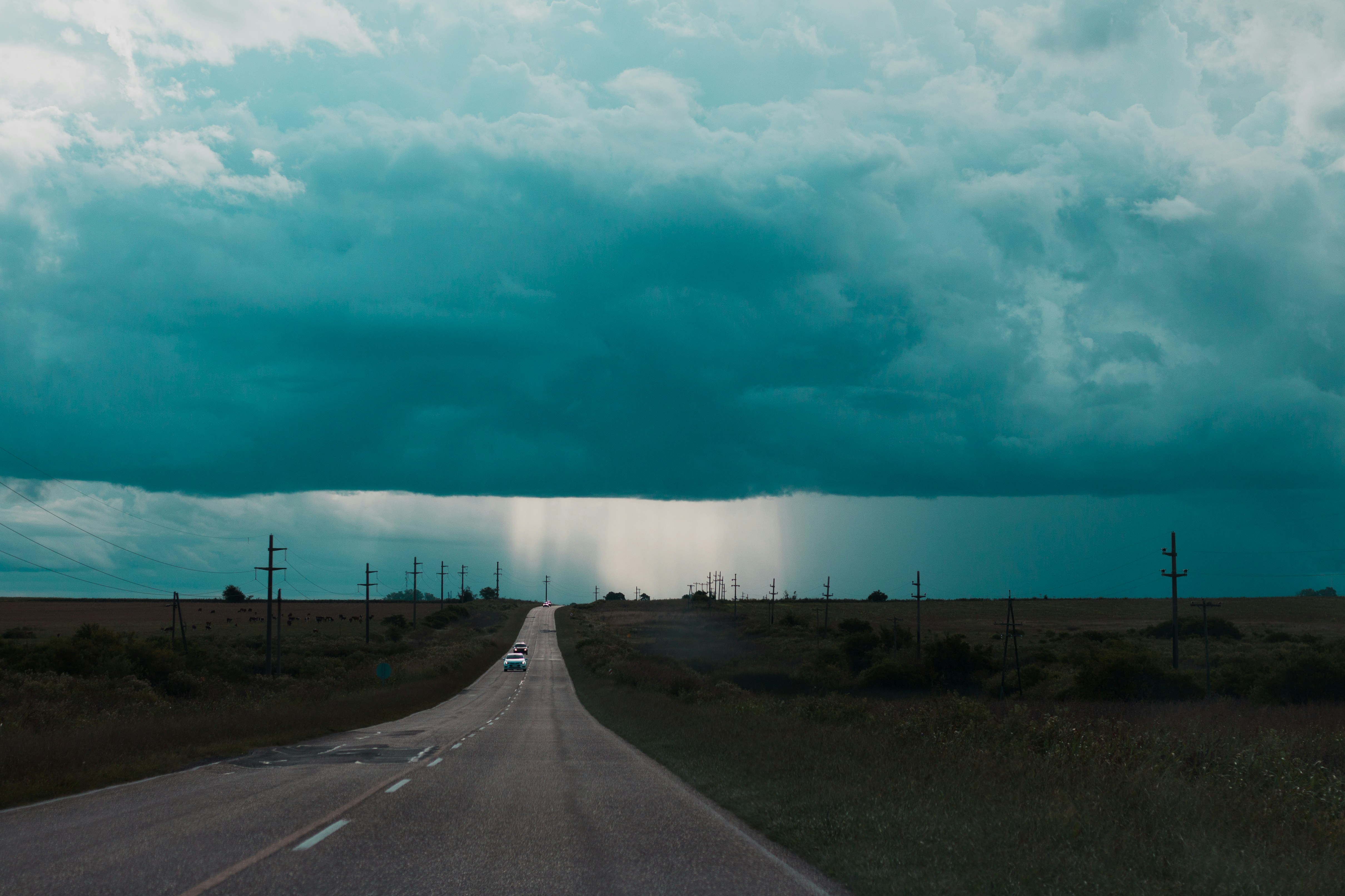 long road under blue skies