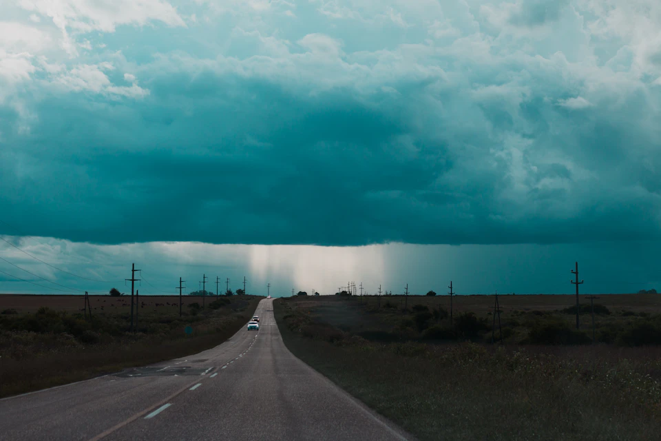Long, straight road stretches into the distance with two white center lines visible