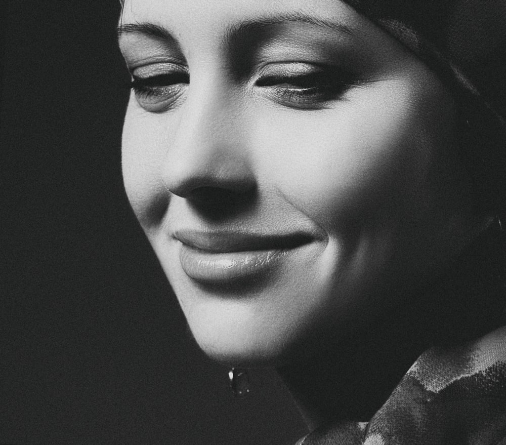 grayscale photography of smiling woman