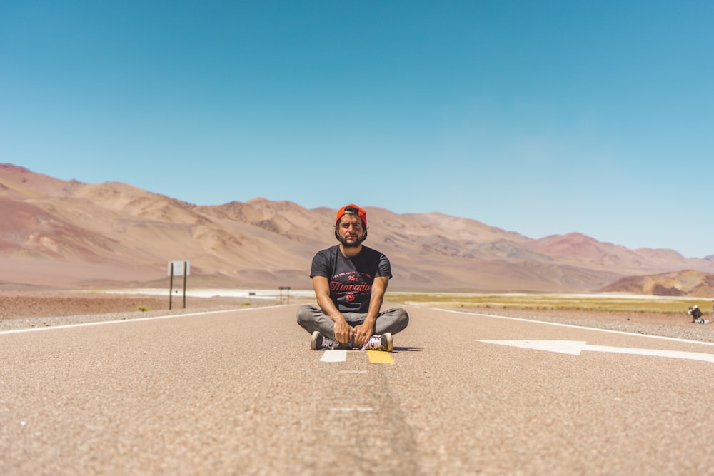 man sitting on road