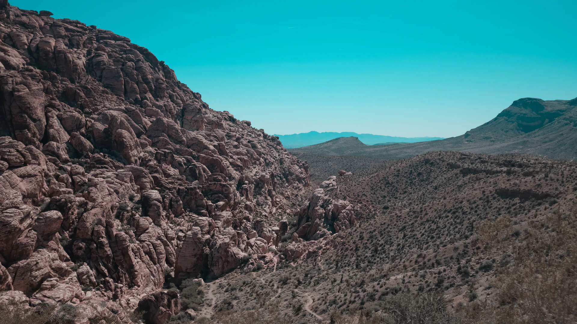 A panoramic shot of the rugged Anti-Atlas northern foothills under a clear blue sky.