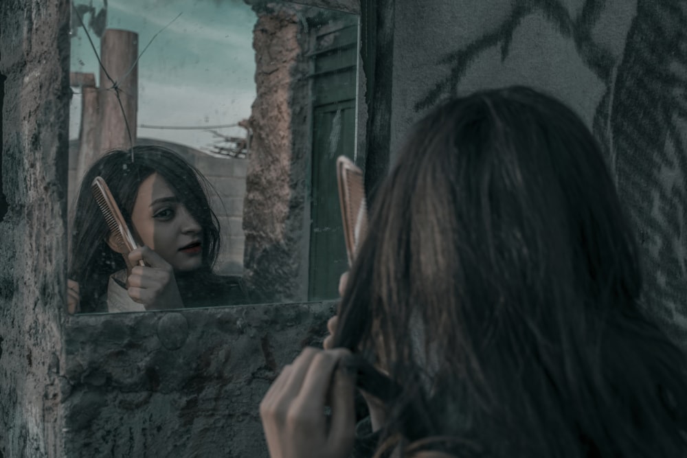 woman combing her hair