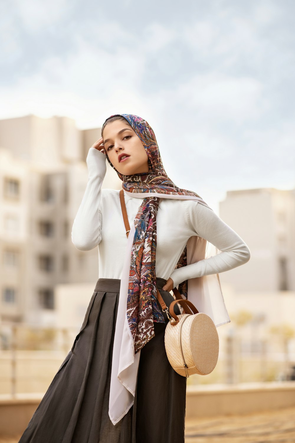 woman wearing white long-sleeved top and black pleated skirt