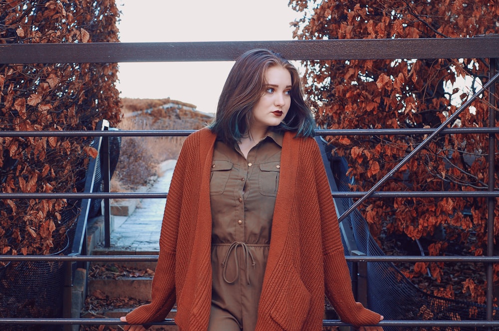 woman wearing brown button-up dress and orange open long-sleeved cardigan during daytime