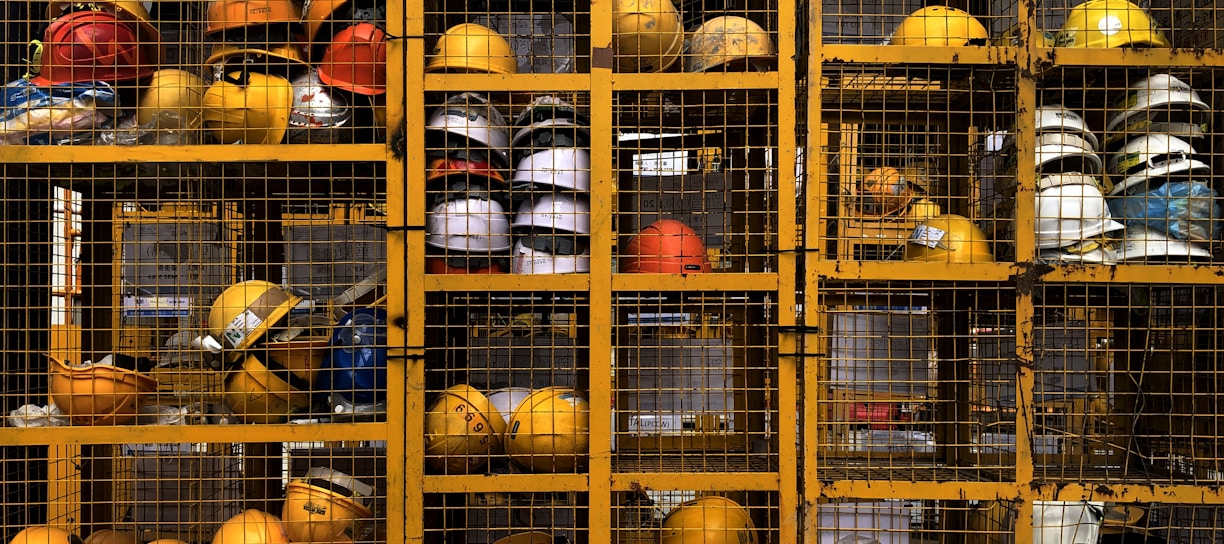 a rack filled with lots of yellow hard hats