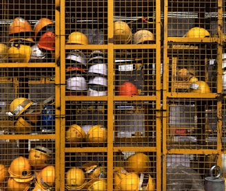 a rack filled with lots of yellow hard hats