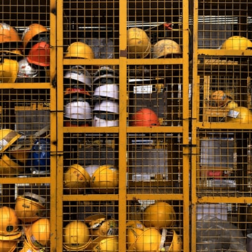 a rack filled with lots of yellow hard hats