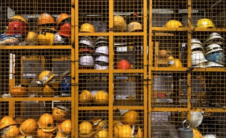 a rack filled with lots of yellow hard hats