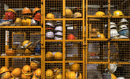 a rack filled with lots of yellow hard hats
